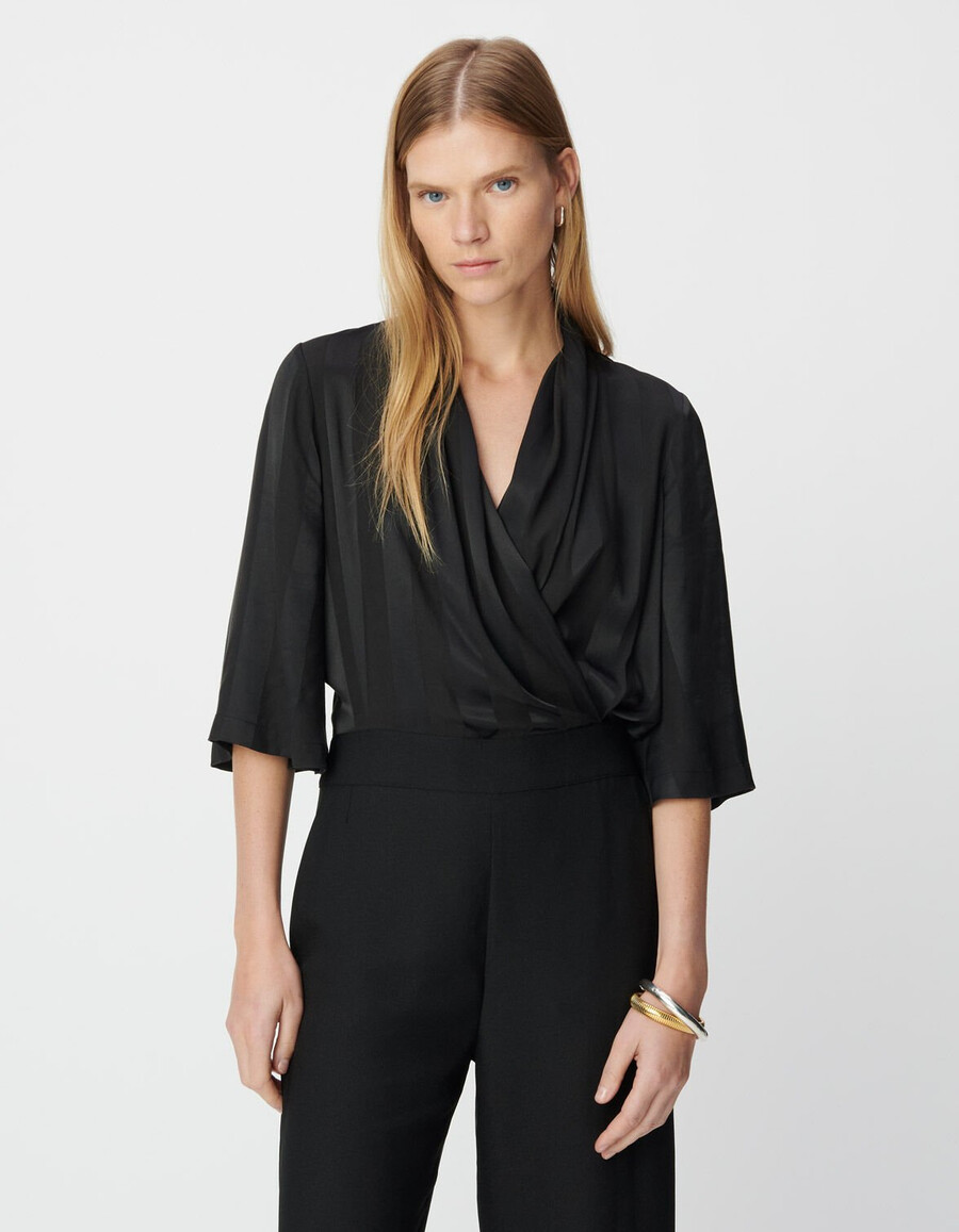 schwarzer damen-jumpsuit aus materialmix mit fließendem oberteil