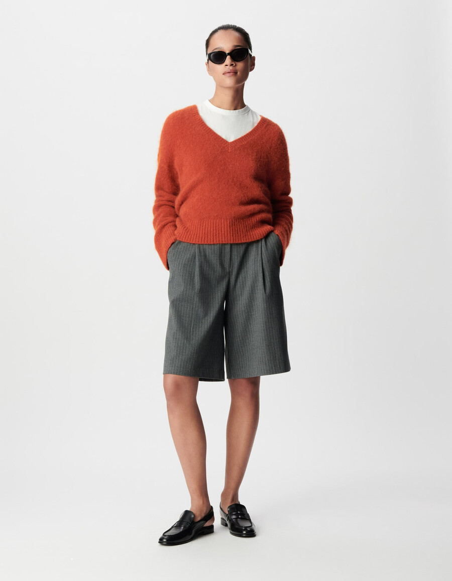 orangefarbener oversize-pullover mit v-ausschnitt für damen