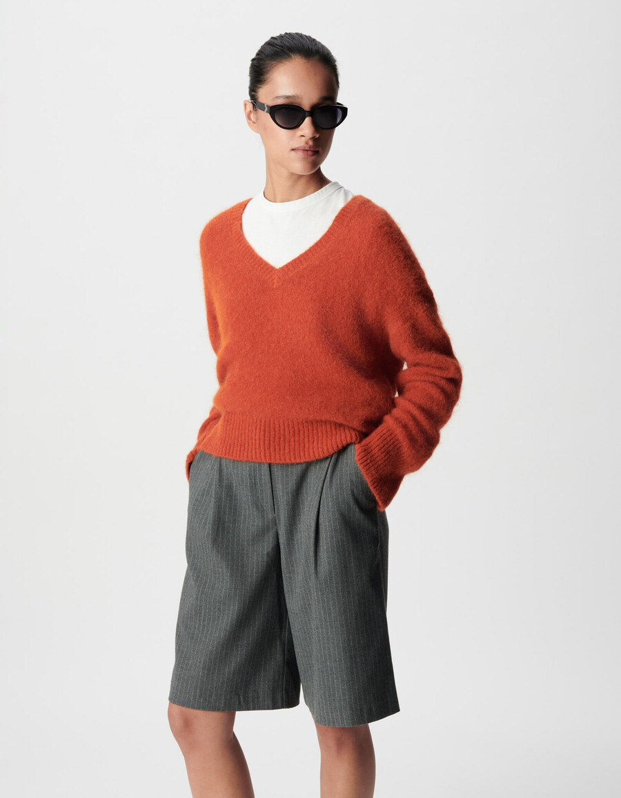 orangefarbener oversize-pullover mit v-ausschnitt für damen