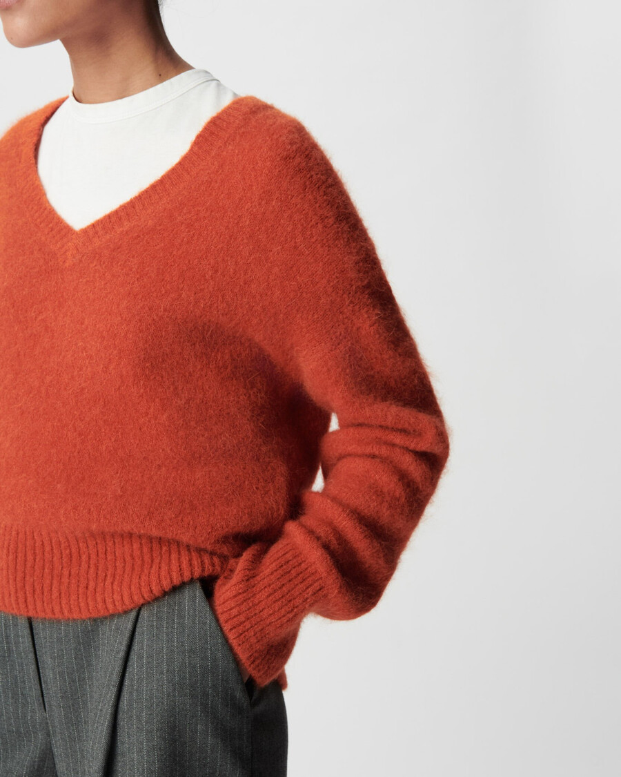 orangefarbener oversize-pullover mit v-ausschnitt für damen